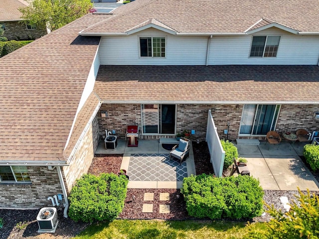 1243 Pond View Cir, De Pere, WI 54115 - view of front of property with a patio, roof with shingles, and brick siding