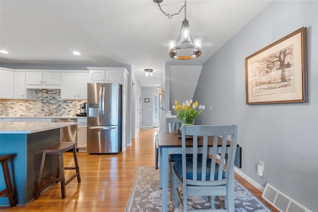 1243 Pond View Cir, De Pere, WI 54115 - dining space featuring light wood-style floors, a chandelier, recessed lighting, and baseboards