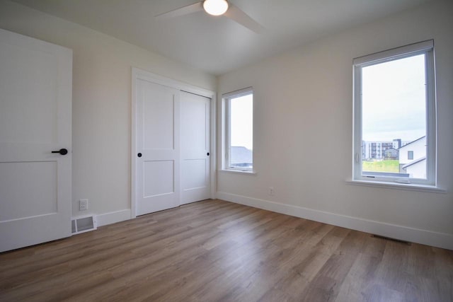 4200 E Lake Vista Blvd, Oak Creek, WI 53154 - unfurnished bedroom featuring wood finished floors, baseboards, a closet, and a ceiling fan