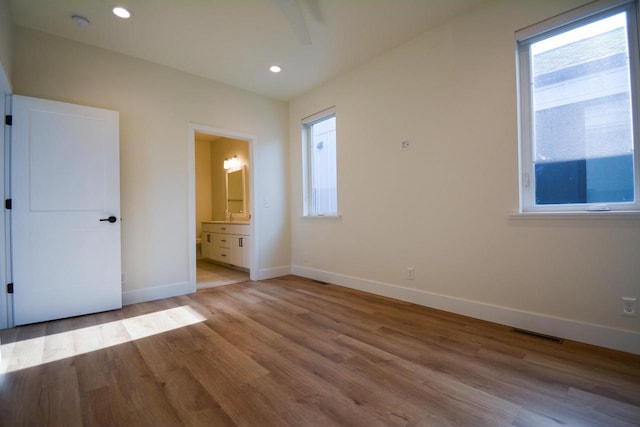 4200 E Lake Vista Blvd, Oak Creek, WI 53154 - unfurnished bedroom with baseboards, wood finished floors, connected bathroom, and recessed lighting