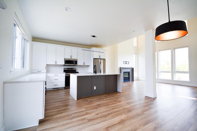 4200 E Lake Vista Blvd, Oak Creek, WI 53154 - kitchen with appliances with stainless steel finishes, white cabinets, light wood finished floors, light countertops, and a high ceiling