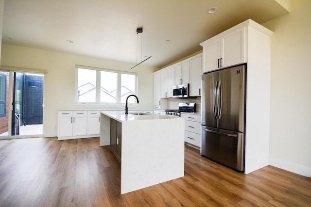 4200 E Lake Vista Blvd, Oak Creek, WI 53154 - kitchen featuring stainless steel appliances, a sink, wood finished floors, light countertops, and backsplash