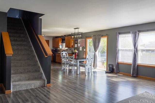 516 Prairie Point Dr, Poplar Grove, IL 61065 - dining room with dark wood-style floors, baseboards, and stairs
