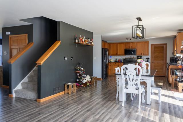 516 Prairie Point Dr, Poplar Grove, IL 61065 - dining room featuring light wood finished floors, stairs, and baseboards