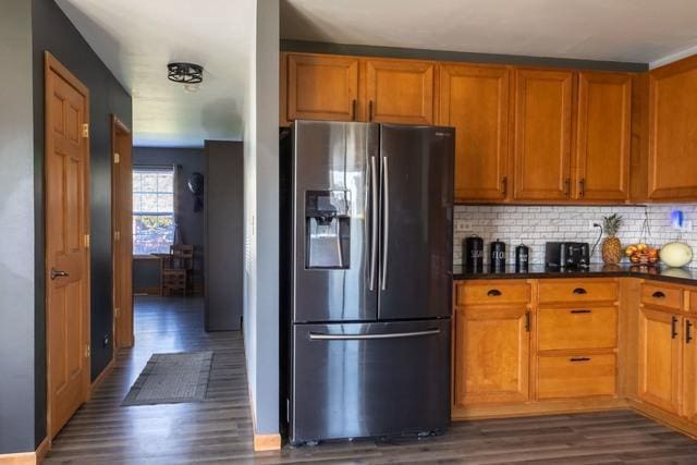 516 Prairie Point Dr, Poplar Grove, IL 61065 - kitchen featuring stainless steel refrigerator with ice dispenser, dark wood-style flooring, dark countertops, decorative backsplash, and brown cabinets