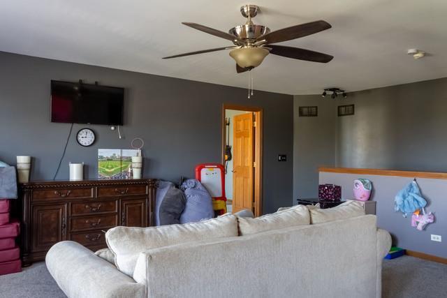 516 Prairie Point Dr, Poplar Grove, IL 61065 - carpeted living room with a ceiling fan and baseboards