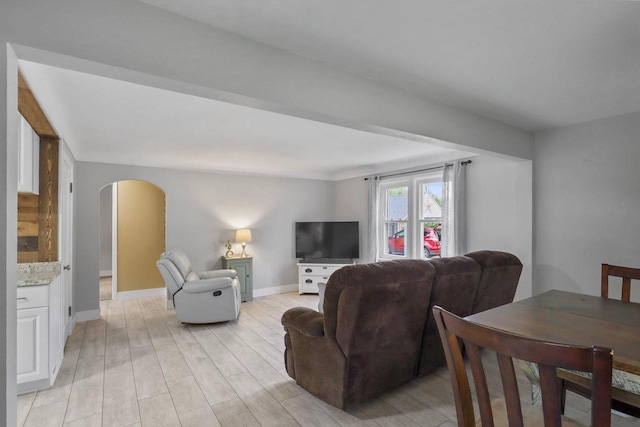 340 12th St S, Wisconsin Rapids, WI 54494 - living room featuring arched walkways, light wood-type flooring, and baseboards