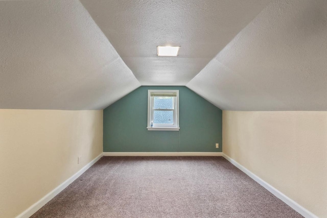 340 12th St S, Wisconsin Rapids, WI 54494 - additional living space with carpet, a textured ceiling, baseboards, and lofted ceiling