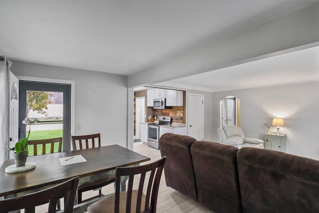 340 12th St S, Wisconsin Rapids, WI 54494 - dining space featuring arched walkways and light wood finished floors