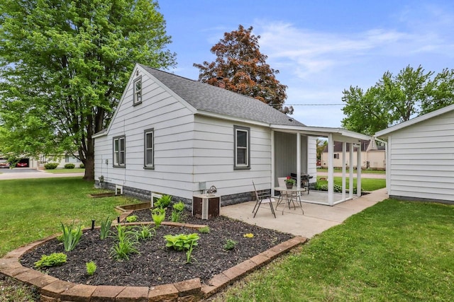 340 12th St S, Wisconsin Rapids, WI 54494 - rear view of house featuring a lawn, a patio area, a shingled roof, and central AC unit