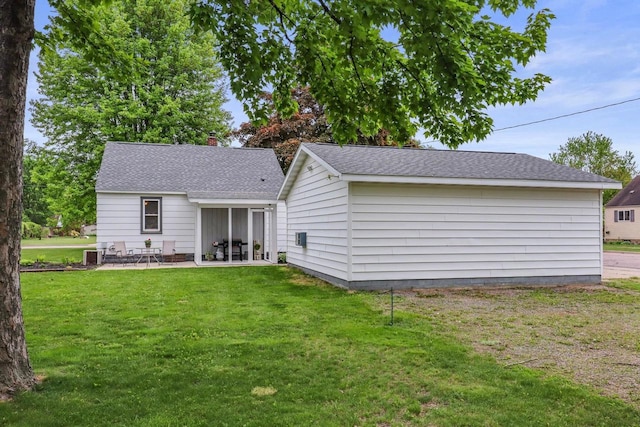 340 12th St S, Wisconsin Rapids, WI 54494 - back of property featuring a lawn, a patio area, central air condition unit, a shingled roof, and a chimney