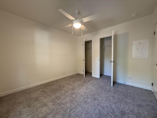 731 Sunset Blvd Unit 29, Wisconsin Dells, WI 53965 - unfurnished bedroom featuring carpet, multiple closets, baseboards, electric panel, and crown molding