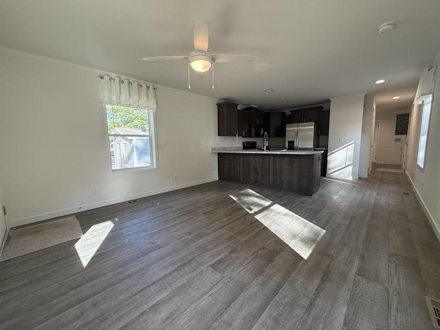 731 Sunset Blvd Unit 29, Wisconsin Dells, WI 53965 - unfurnished living room featuring plenty of natural light, dark wood-type flooring, baseboards, and recessed lighting