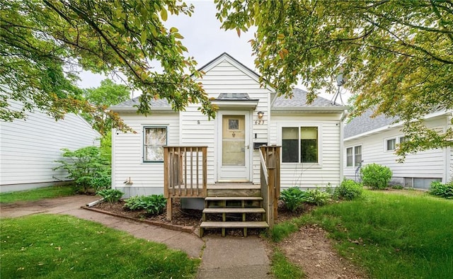 623 Starr Ave, Eau Claire, WI 54703 - view of front of home with a wooden deck, a front yard, and roof with shingles