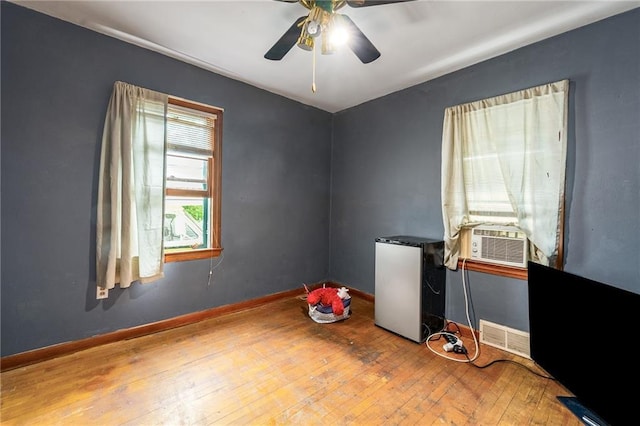 623 Starr Ave, Eau Claire, WI 54703 - empty room featuring cooling unit, hardwood / wood-style floors, a ceiling fan, and baseboards