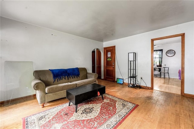 623 Starr Ave, Eau Claire, WI 54703 - living room with arched walkways, wood finished floors, and baseboards