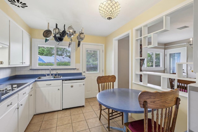219 Summit St, Portage, WI 53901 - kitchen with white dishwasher, a sink, a chandelier, and white cabinetry
