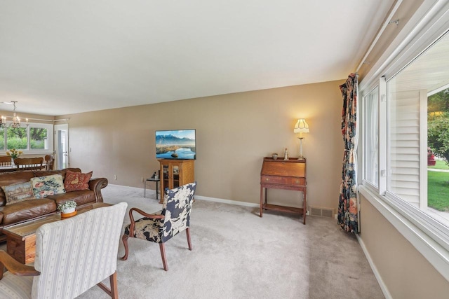 219 Summit St, Portage, WI 53901 - living room featuring light colored carpet, baseboards, and a chandelier