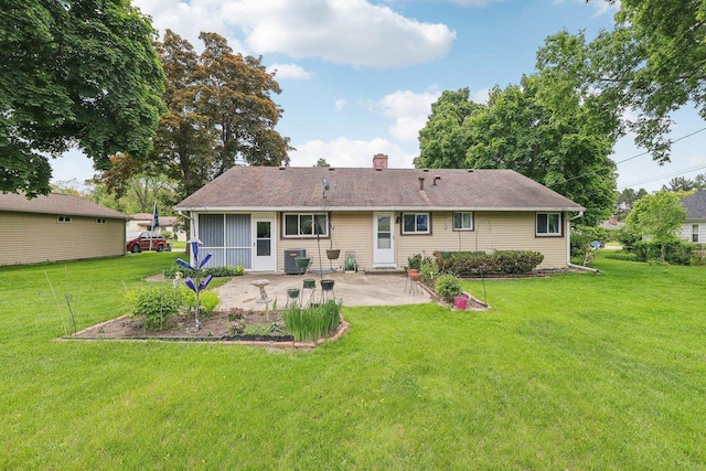 219 Summit St, Portage, WI 53901 - rear view of property featuring a patio area, a yard, and a chimney