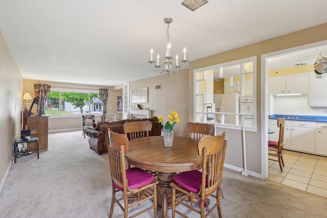 219 Summit St, Portage, WI 53901 - dining area with a chandelier, light carpet, baseboards, and light tile patterned floors