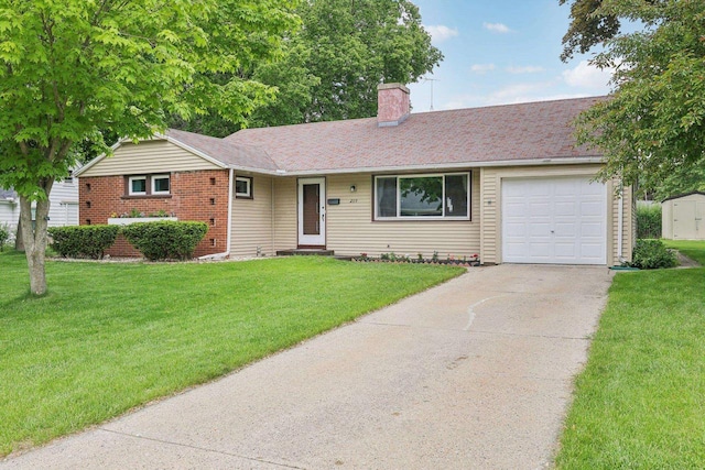 219 Summit St, Portage, WI 53901 - ranch-style home featuring a chimney, a garage, concrete driveway, and a front lawn