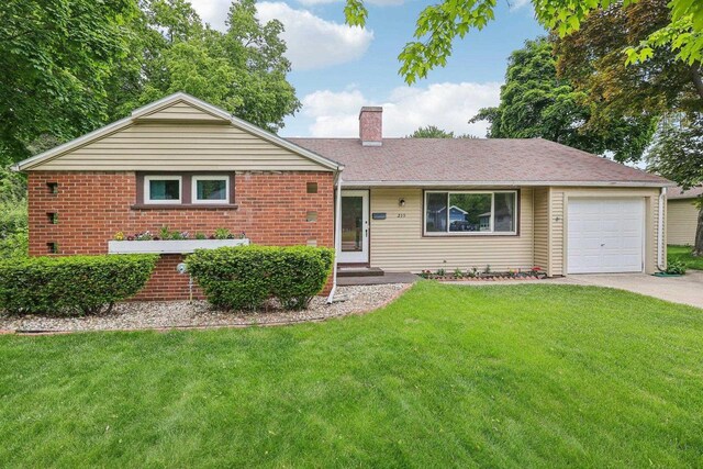 219 Summit St, Portage, WI 53901 - ranch-style home with a chimney, a front lawn, concrete driveway, and brick siding