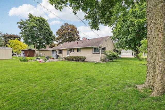 219 Summit St, Portage, WI 53901 - rear view of house with a yard and a chimney