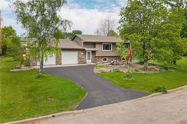 12924 Thomas St, Osseo, WI 54758 - view of front of property featuring stone siding, an attached garage, a front yard, and asphalt driveway
