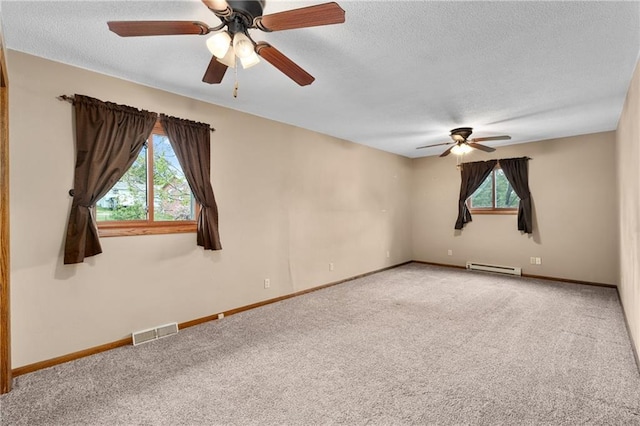 12924 Thomas St, Osseo, WI 54758 - unfurnished room with a baseboard heating unit, ceiling fan, carpet, plenty of natural light, and a textured ceiling