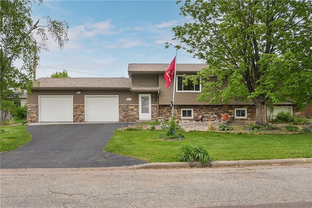 12924 Thomas St, Osseo, WI 54758 - split level home with a garage, stone siding, a front yard, and asphalt driveway