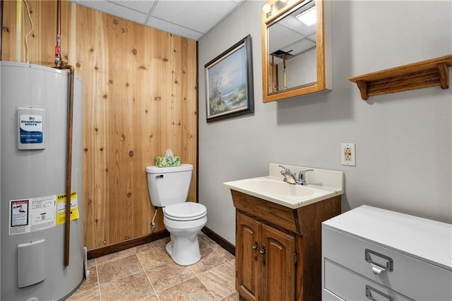 12924 Thomas St, Osseo, WI 54758 - bathroom with water heater, toilet, vanity, a drop ceiling, and baseboards