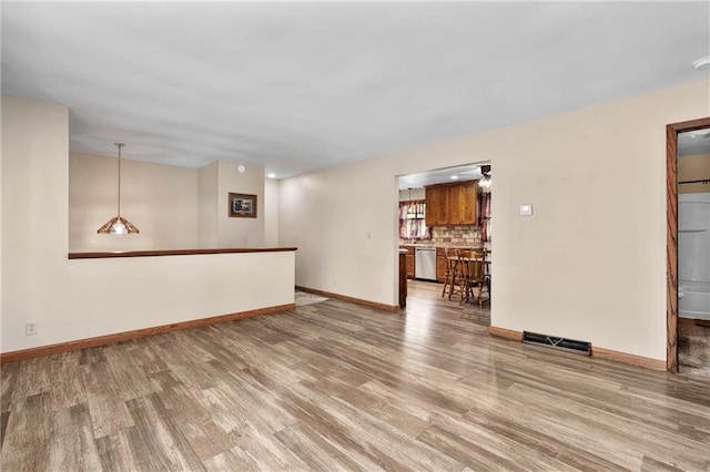 12924 Thomas St, Osseo, WI 54758 - unfurnished living room featuring wood finished floors and baseboards
