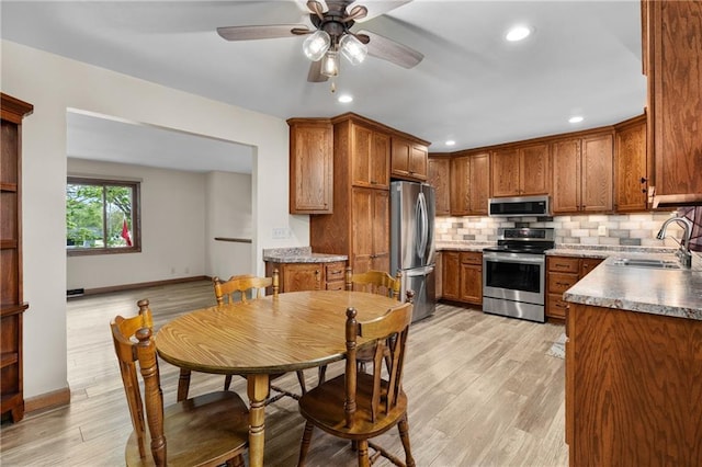 12924 Thomas St, Osseo, WI 54758 - kitchen with appliances with stainless steel finishes, a sink, tasteful backsplash, baseboards, and recessed lighting