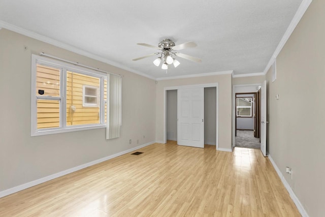 6170 N 36th St, Milwaukee, WI 53209 - unfurnished bedroom with light wood-style flooring, a closet, baseboards, crown molding, and a ceiling fan