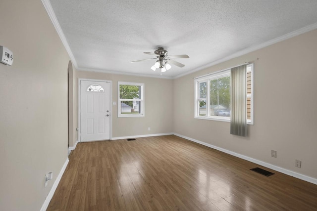 6170 N 36th St, Milwaukee, WI 53209 - entrance foyer with a ceiling fan, a textured ceiling, crown molding, plenty of natural light, and wood finished floors