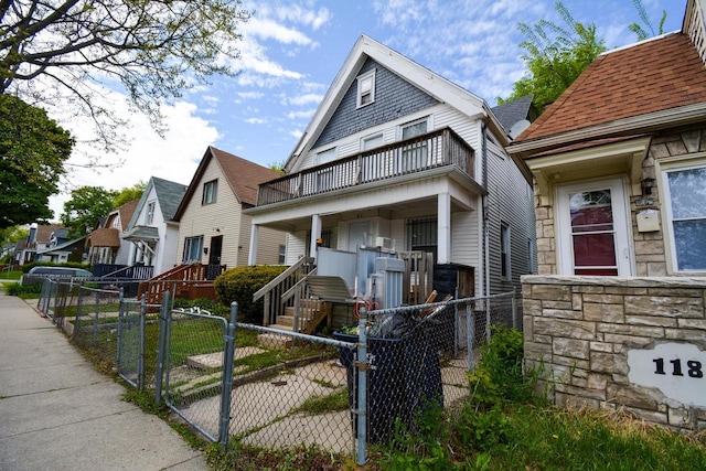 116 E Concordia Ave, Milwaukee, WI 53212 - view of front of property featuring a balcony, a gate, a fenced front yard, and stone siding