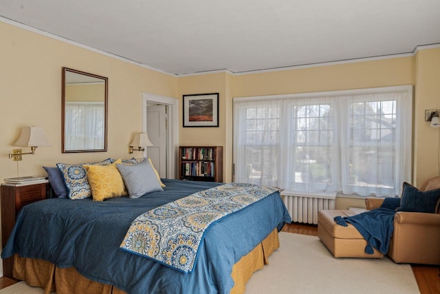 2615 N Summit Ave, Milwaukee, WI 53211 - bedroom featuring radiator heating unit, wood finished floors, and crown molding
