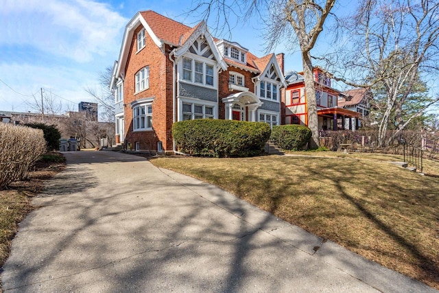 2615 N Summit Ave, Milwaukee, WI 53211 - view of front of property featuring brick siding, concrete driveway, a front yard, and a residential view
