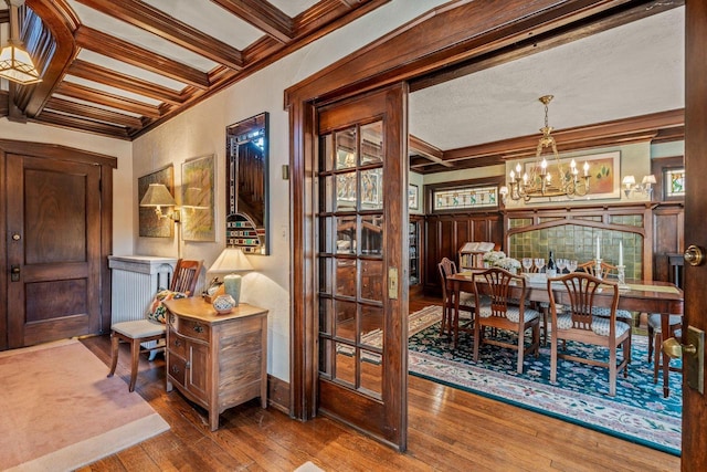 2615 N Summit Ave, Milwaukee, WI 53211 - dining space featuring crown molding, a chandelier, wood-type flooring, coffered ceiling, and beam ceiling