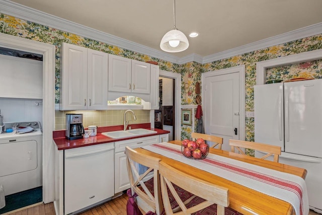 2615 N Summit Ave, Milwaukee, WI 53211 - kitchen with washer / dryer, a sink, white appliances, wallpapered walls, and tasteful backsplash