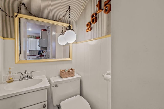 2615 N Summit Ave, Milwaukee, WI 53211 - half bath featuring toilet, vanity, and wainscoting
