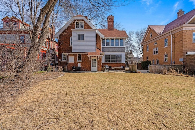 2615 N Summit Ave, Milwaukee, WI 53211 - rear view of house featuring brick siding, a yard, and a chimney