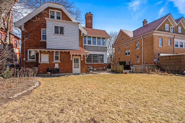 2615 N Summit Ave, Milwaukee, WI 53211 - back of property featuring brick siding, a yard, a patio area, and a chimney