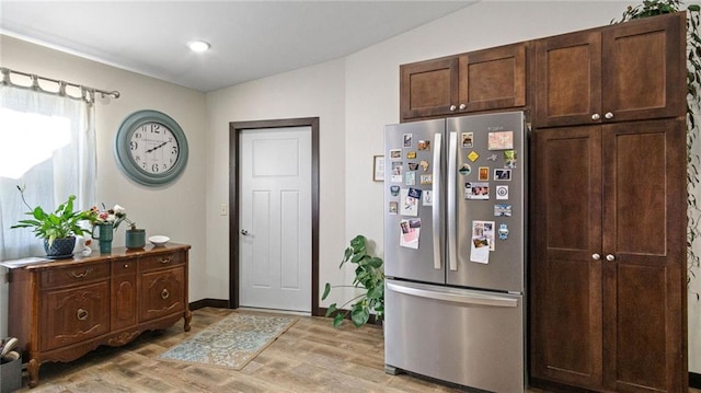 18925 63rd Ave Unit A1, Chippewa Falls, WI 54729 - kitchen featuring freestanding refrigerator, light wood-style floors, baseboards, and dark brown cabinetry