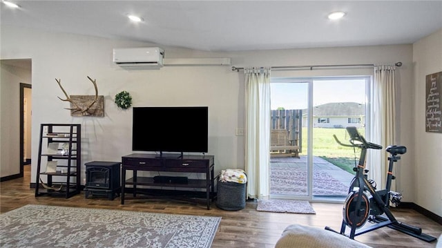 18925 63rd Ave Unit A1, Chippewa Falls, WI 54729 - workout room featuring a wall unit AC, a wood stove, wood finished floors, baseboards, and recessed lighting