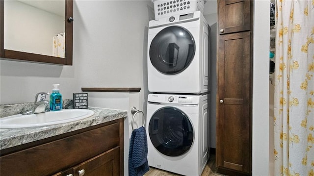 18925 63rd Ave Unit A1, Chippewa Falls, WI 54729 - washroom with estacked washer and dryer, light wood-style floors, and cabinet space
