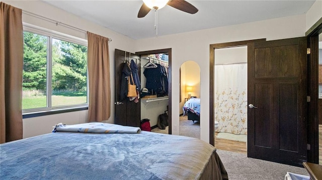 18925 63rd Ave Unit A1, Chippewa Falls, WI 54729 - bedroom featuring arched walkways, carpet flooring, connected bathroom, and ceiling fan