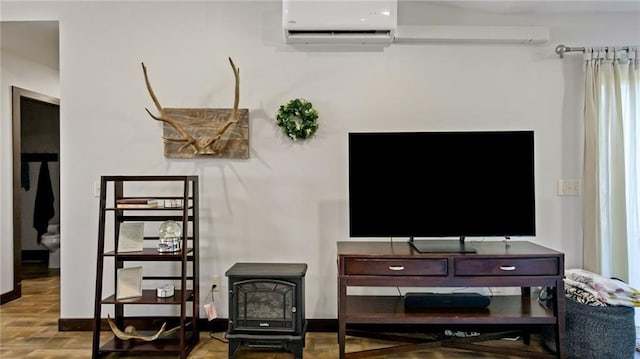 18925 63rd Ave Unit A1, Chippewa Falls, WI 54729 - living room with a wall unit AC, wood finished floors, a wood stove, and baseboards