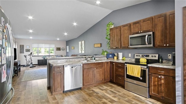 18925 63rd Ave Unit A1, Chippewa Falls, WI 54729 - kitchen featuring stainless steel appliances, a sink, a peninsula, lofted ceiling, and open floor plan