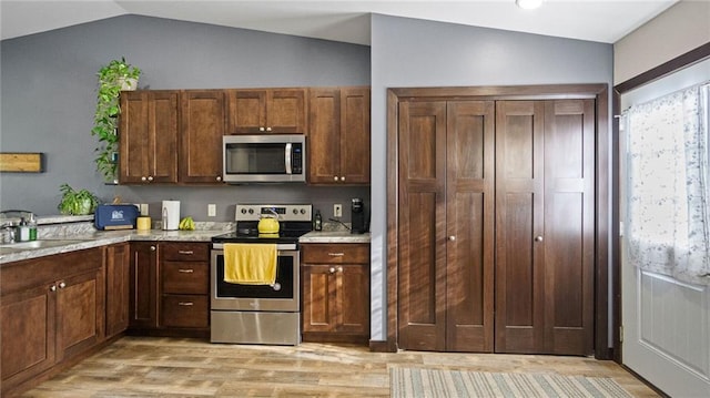 18925 63rd Ave Unit A1, Chippewa Falls, WI 54729 - kitchen with appliances with stainless steel finishes, vaulted ceiling, light wood finished floors, and a sink